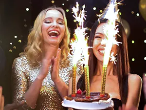 Two women celebrating a birthday with a sparkler cake — Casa Sensei, Fort Lauderdale
