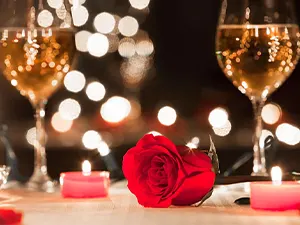 Romantic table setting with a red rose, candlelight, and champagne glasses — Casa Sensei, Fort Lauderdale