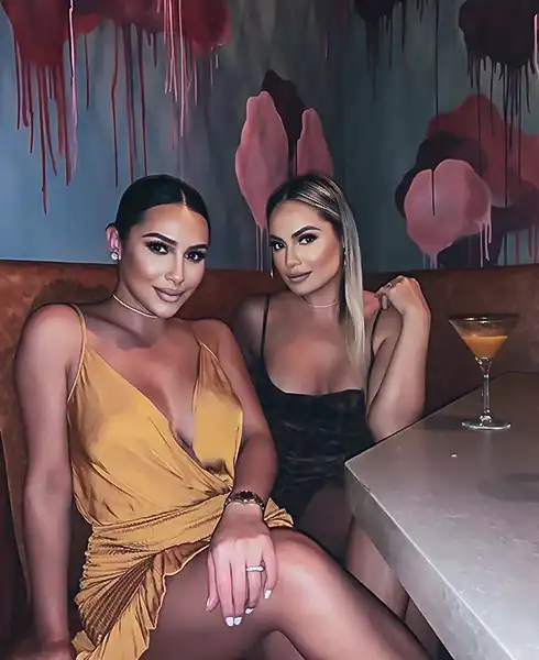 Two guests enjoying a night out, seated at a booth with a martini cocktail — Casa Sensei, Fort Lauderdale